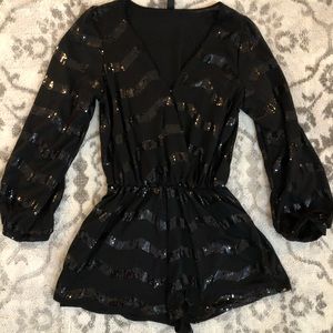 Black, sequence long sleeve shorts romper. Brand new- no tags.